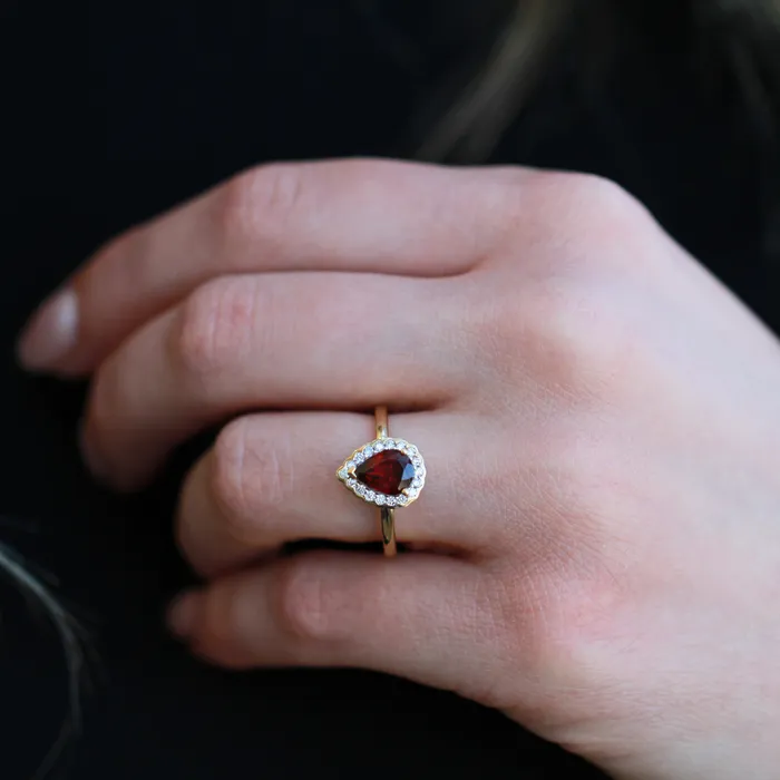 Rings Diamond Evolution 10kt Yellow Gold Garnet Pear Cut with Diamond Halo Ring Rings Diamond Evolution 10kt Yellow Gold Garnet Pear Cut with Diamond Halo Ring